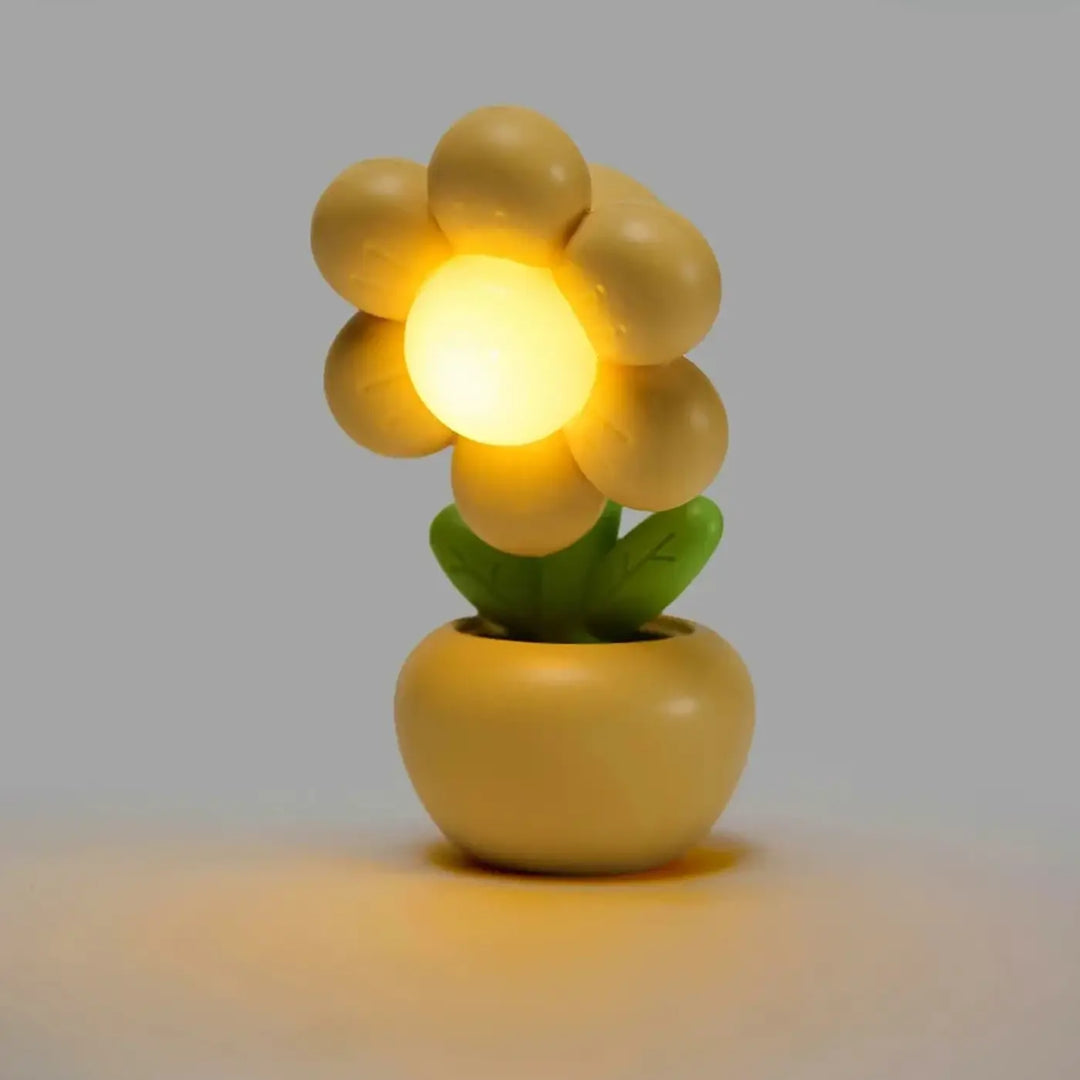 Veilleuse flow en forme de fleur jaune chaude avec lumière douce et objet décoratif dans pot assorti vert