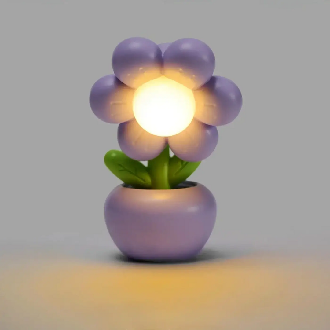 Veilleuse flow en forme de fleur violette avec lumière douce centrale et tige verte dans pot décoratif assorti