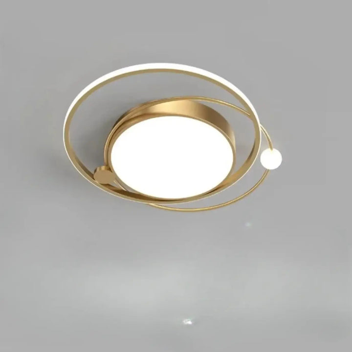 Luminaire plafonnier aloïs moderne en métal doré avec anneaux circulaires concentriques et lumière blanche pour salle à manger