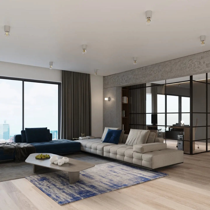 Beige canapé d’angle capitonné avec coussins bleu marine associé à l’applique murale salgado en béton style loft