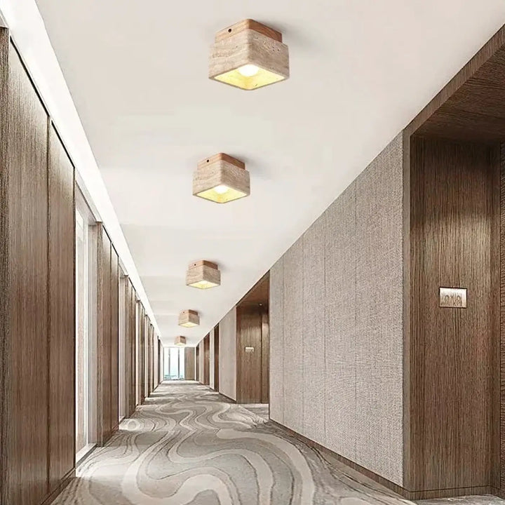 Plafonnier design carré en bois naturel avec finition pierre rustique émettant une lumière jaune chaleureuse pour décoration intérieure