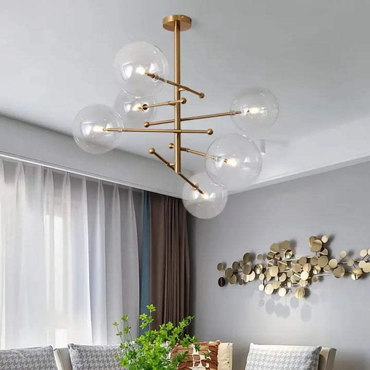 Plafonnier moderne atomix en laiton doré avec globe en verre clair pour salle à manger élégante