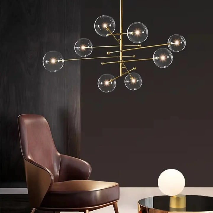 Plafonnier moderne atomix en laiton doré avec globes en verre clair idéal pour salle à manger