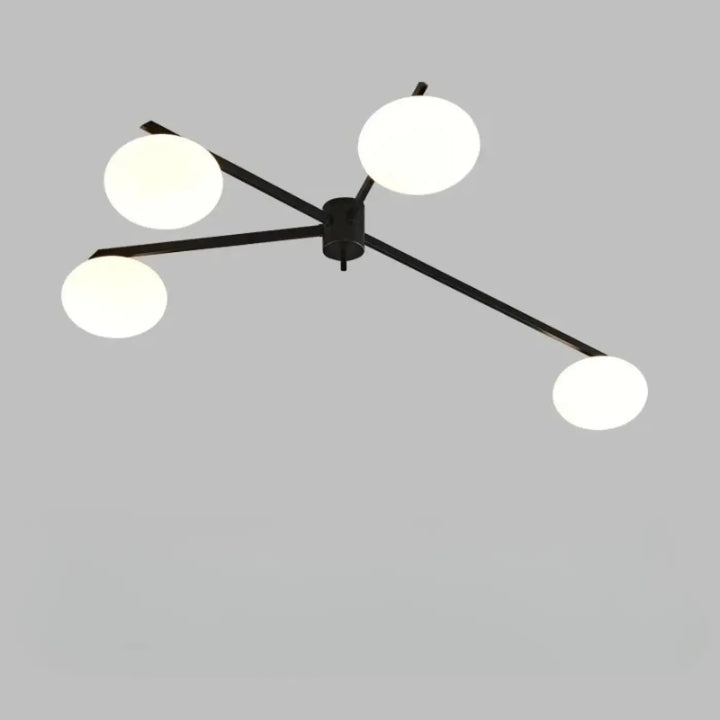 Plafonnier moderne en métal noir xILYS avec quatre globes en verre blanc et bras graphiques élégants