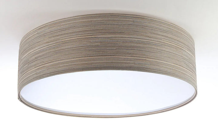 Luminaire plafonnier rond avec abat-jour cylindrique en tissu taupe texturé offrant une dimension à l’éclairage moderne