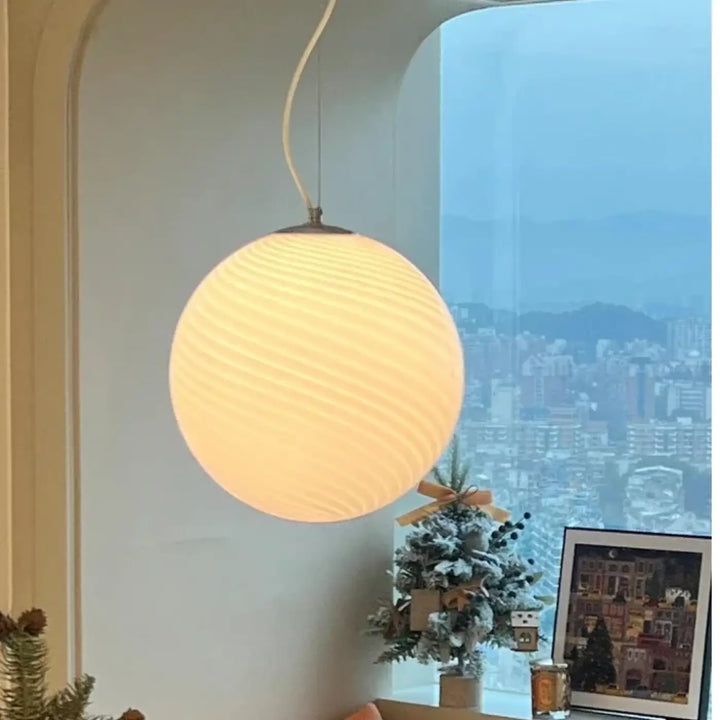Suspension luminaire lolly spherical warm-toned with ribbed texture and soft glow luminaire contemporaine