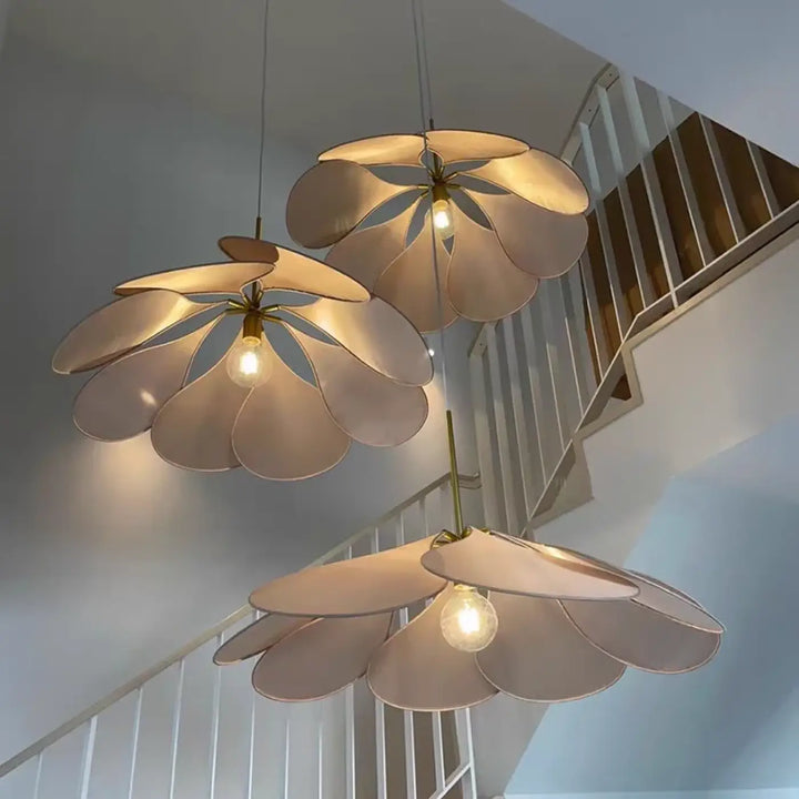 Three cream-colored floral suspension luminaires anthia with layered petals and brass-toned centers for elegant suspension luminaire design