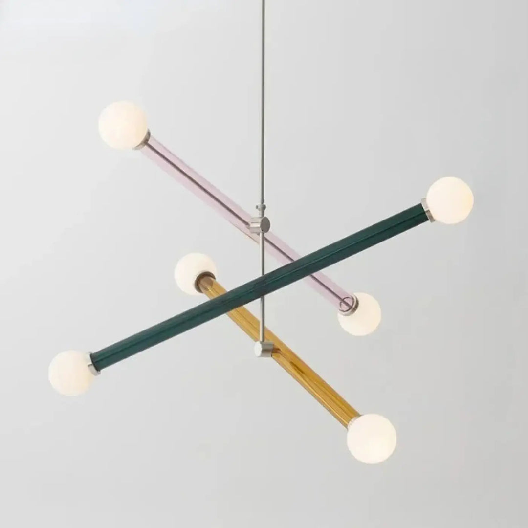 Modern geometric suspension luminaire design with intersecting matte green, lavender, and natural wood rods ending in frosted globes