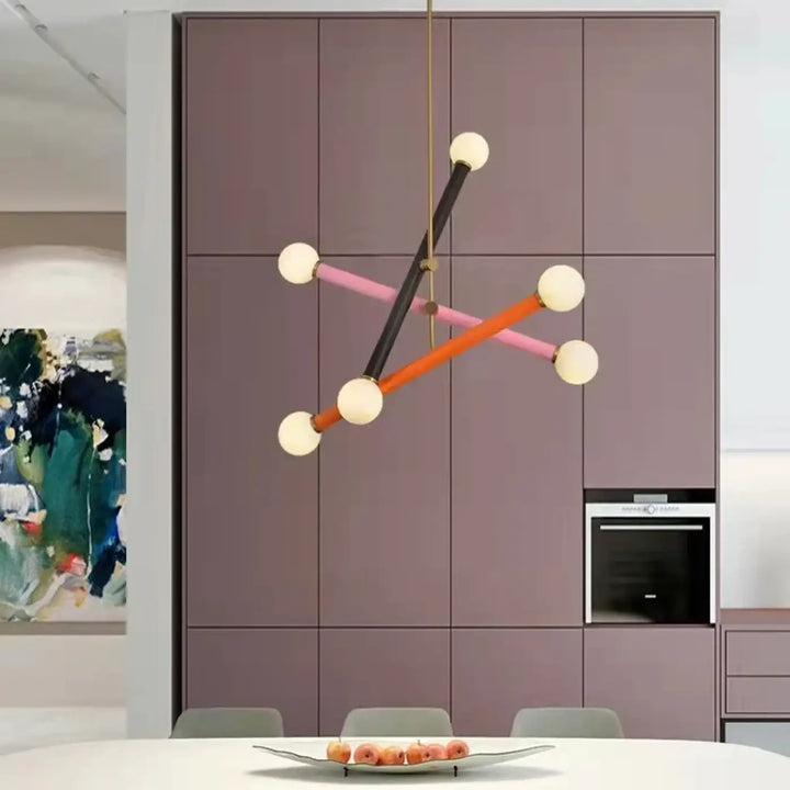 Suspension luminaire equis avec design géométrique en tiges noires, orange et roses tenant des ampoules blanches sphériques