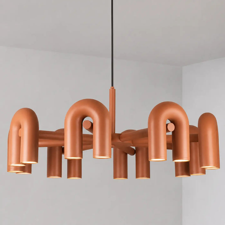 Suspension luminaire copper color with industrial-style curved pipe arms and cylindrical light fixtures luminaire design ural