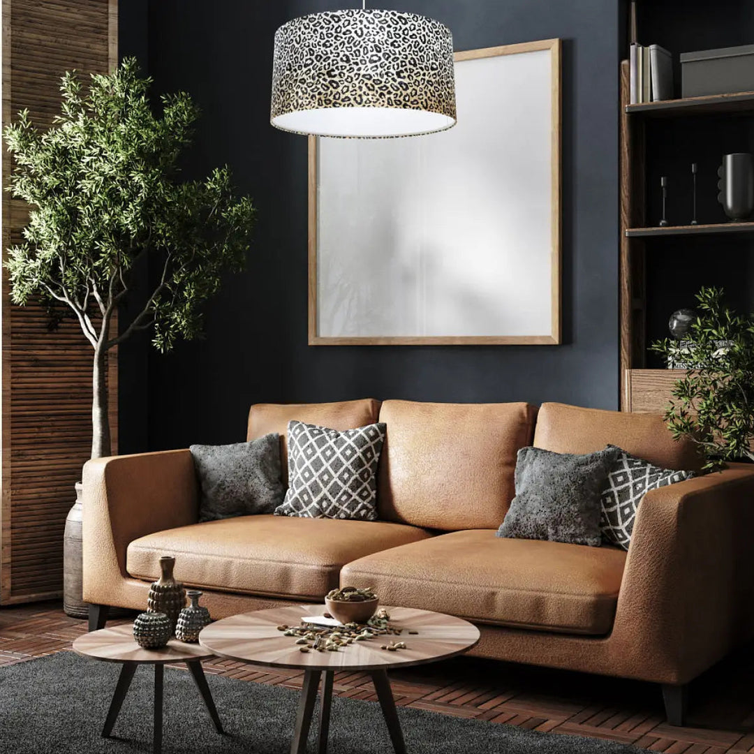 Canapé en cuir tan avec coussins gris à motifs design léopard pour suspension luminaire safari crème noir