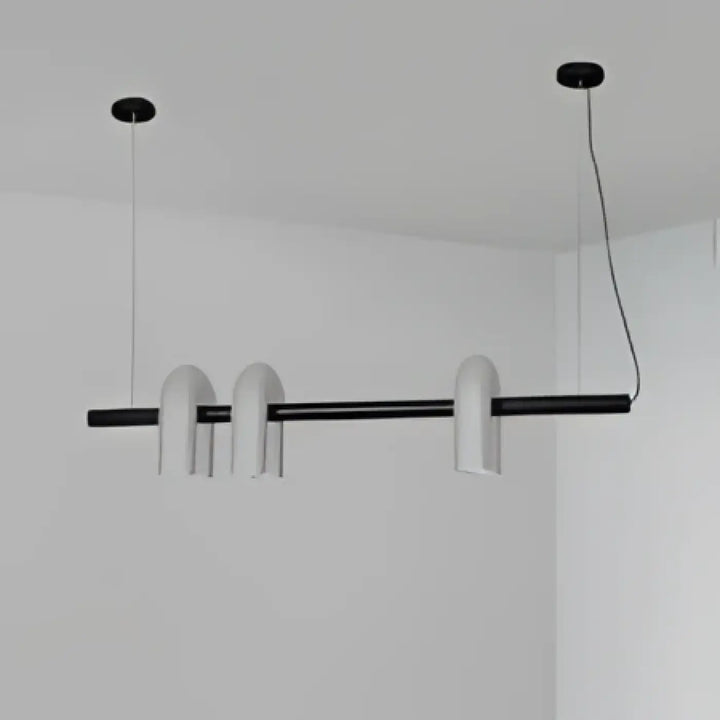Modern black and white minimalist suspension luminaire with sleek cylindrical shades by onda luminaire design