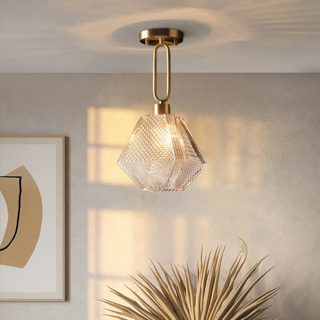 Suspension luminaire eclat en verre texturé hexagonal clair avec fixation en métal finition laiton et design élégant