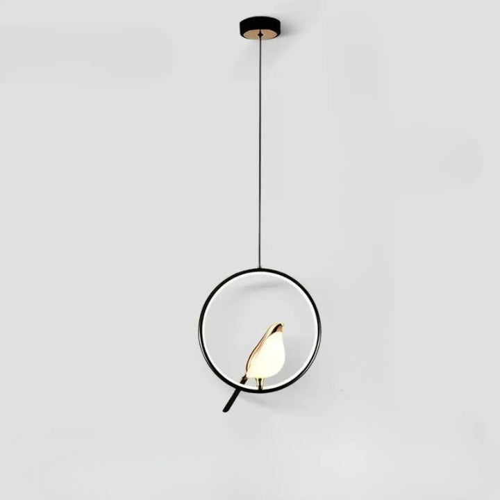 Suspension luminaire fody noir minimaliste avec halo lumineux oiseau doré sur branche au centre du design circulaire
