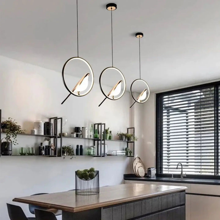 Suspension luminaire fody avec trois halos lumineux noirs et découpes d oiseaux illuminés pour un design moderne