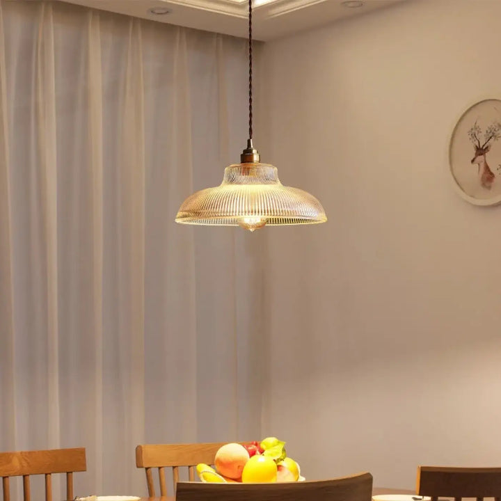 Suspension luminaire vynz en verre côtelé ton chaud avec fixation métal finition laiton et cordon noir pour zone déclairage optimale