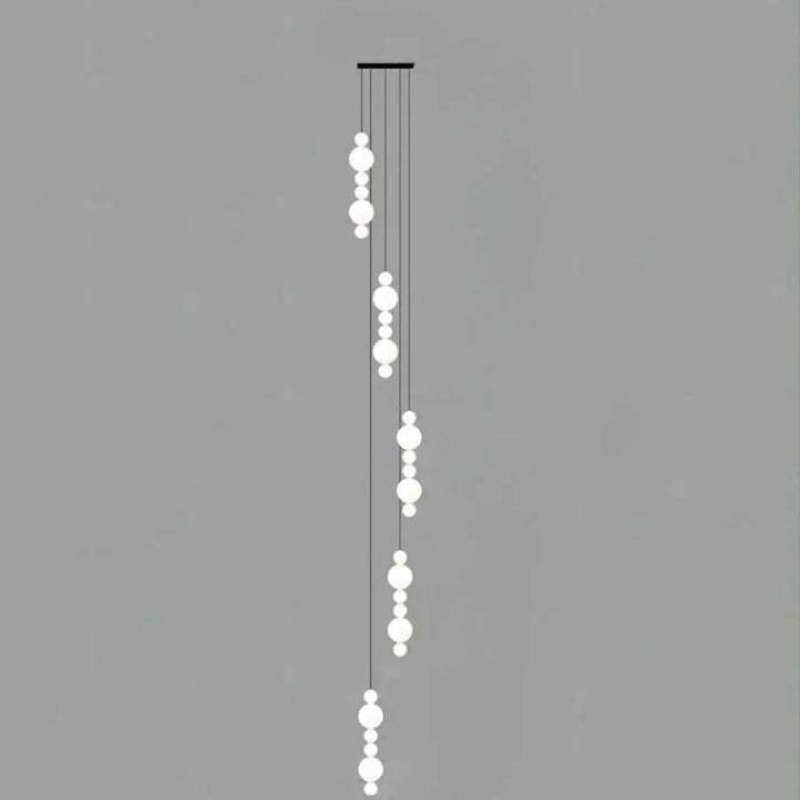 Suspension luminaire oxyo en forme de boule opaline blanche moderne avec cordons noirs minimalistes en chute verticale