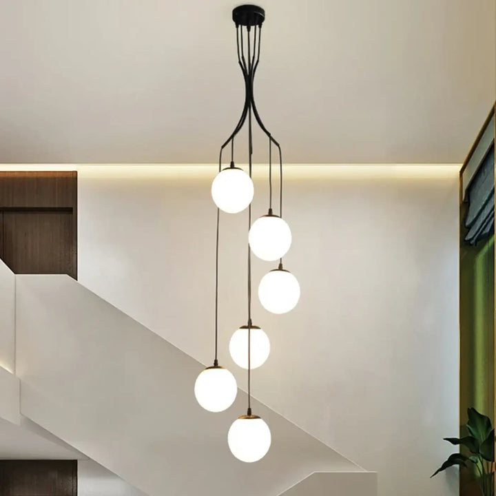 Suspension luminaire umami en métal noir moderne avec cinq globes en verre blanc sphériques lumineux