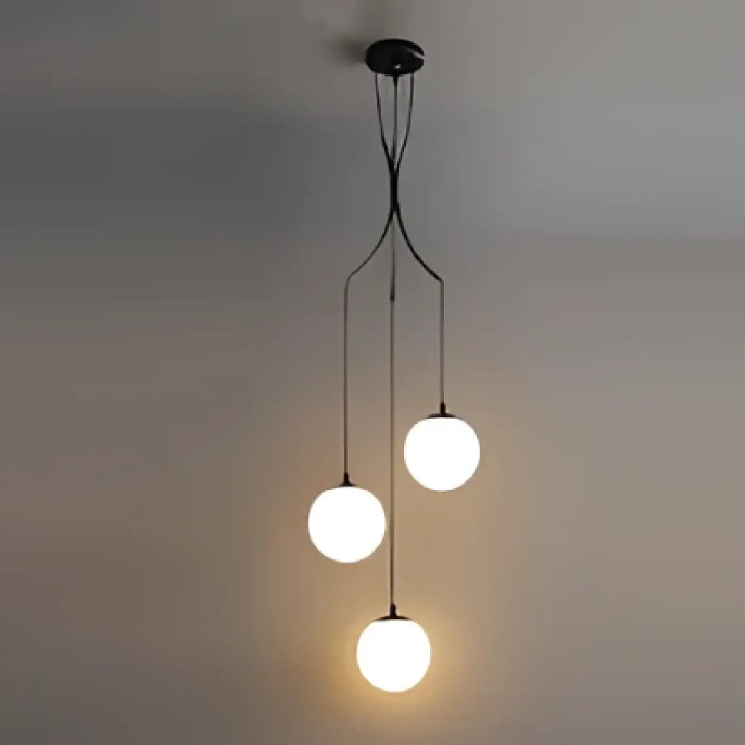Suspension luminaire umami en métal noir moderne avec quatre ampoules sphériques en verre lumineux