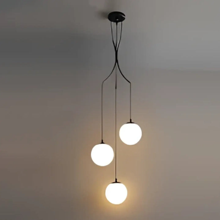 Suspension luminaire umami en métal noir moderne avec quatre ampoules sphériques en verre lumineux