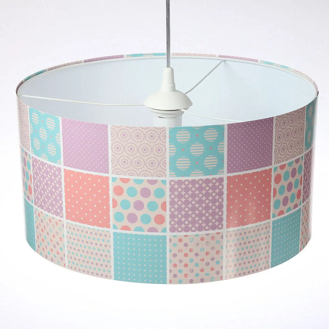 Pastel-colored patchwork suspension luminaire enfant with polka dots and geometric patterns in soft pinks blues and purples
