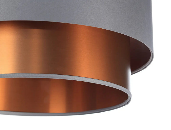 Suspension luminaire gris avec design moderne cuivré, abat-jour cylindrique mat et intérieur cuivre brossé chaleureux