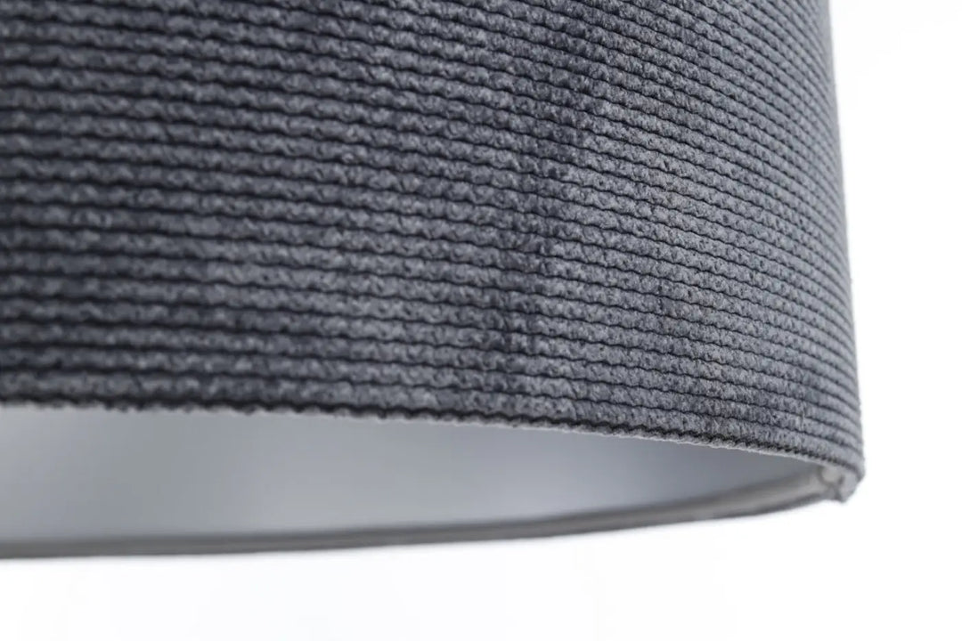 Suspension luminaire glamour structural velour en tissu graphite avec abat-jour texturé au-dessus d’une table