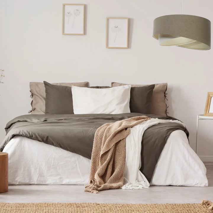 Cozy bed with tissu gris marron bedding featuring a dark gray duvet and beige knit throw in suspension luminaire style
