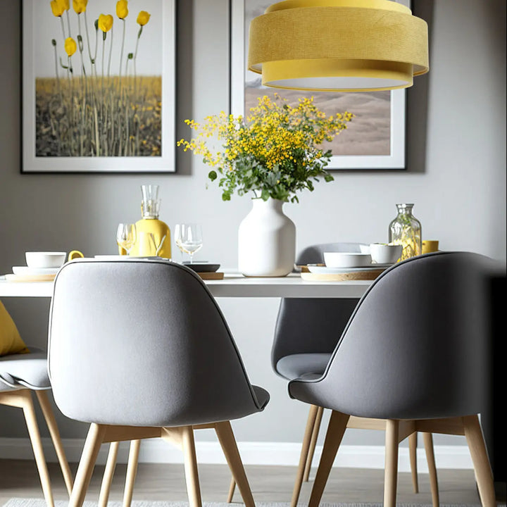 Modern gray upholstered dining chairs with light wood legs complement suspension luminaire doblo classic tissu jaune blanc aux finitions