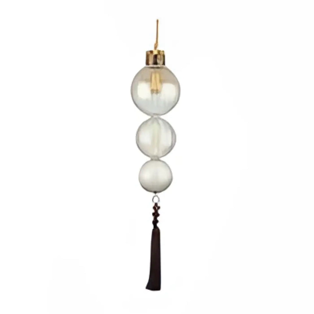 Suspension luminaire medina en verre clair avec accents métalliques dorés et pampille noire, plus qu’un luminaire verre teinté