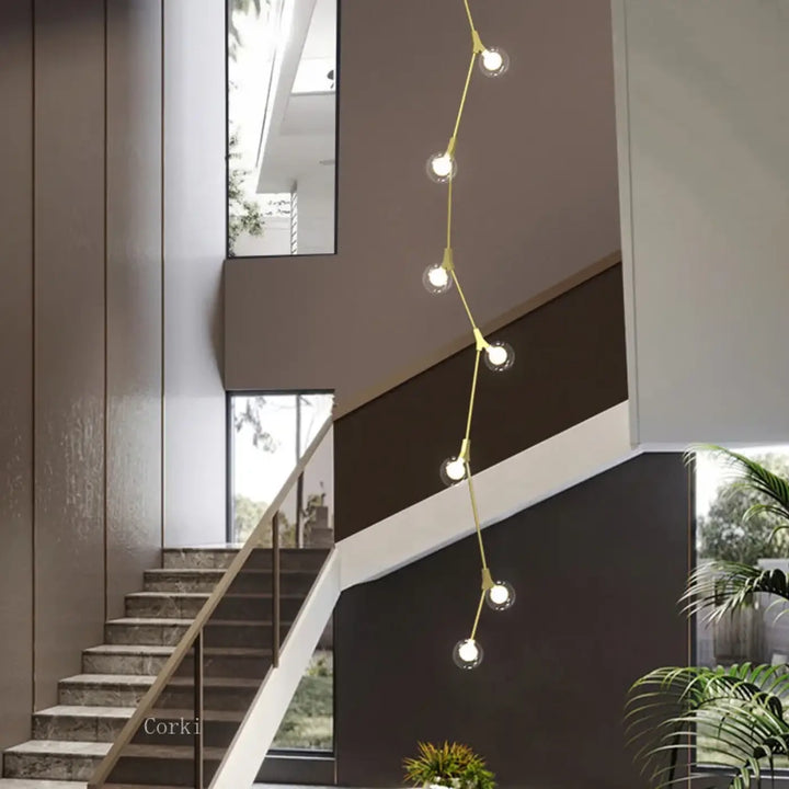 Suspension luminaire verticale en boules opales et laiton