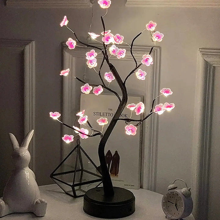 Veilleuse arbre lumineux flowy avec fleurs roses led et branches noires sur base circulaire pour décoration intérieure