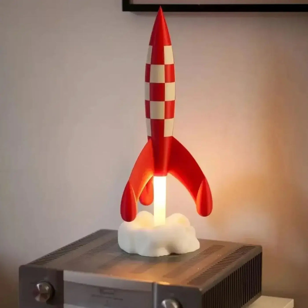 Veilleuse cosmique stellaire en forme de fusée rouge à carreaux blancs avec base lumineuse pour une ambiance douce