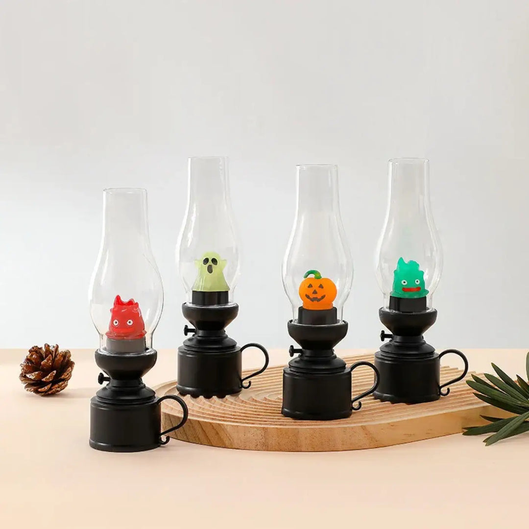 Set de quatre veilleuses led effet noir avec cheminée en verre et figurines halloween colorées pour décoration intérieure