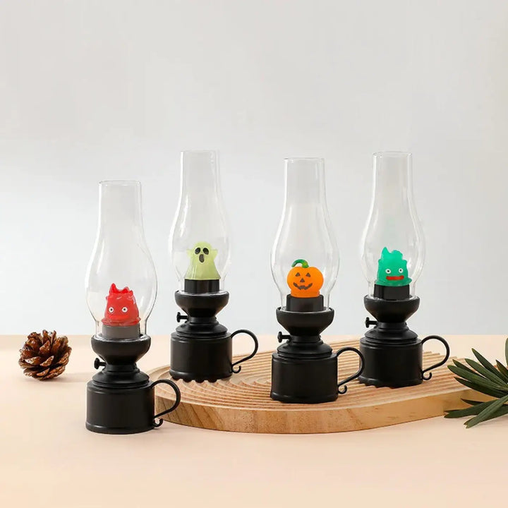 Set de quatre veilleuses led effet noir avec cheminée en verre et figurines halloween colorées pour décoration intérieure
