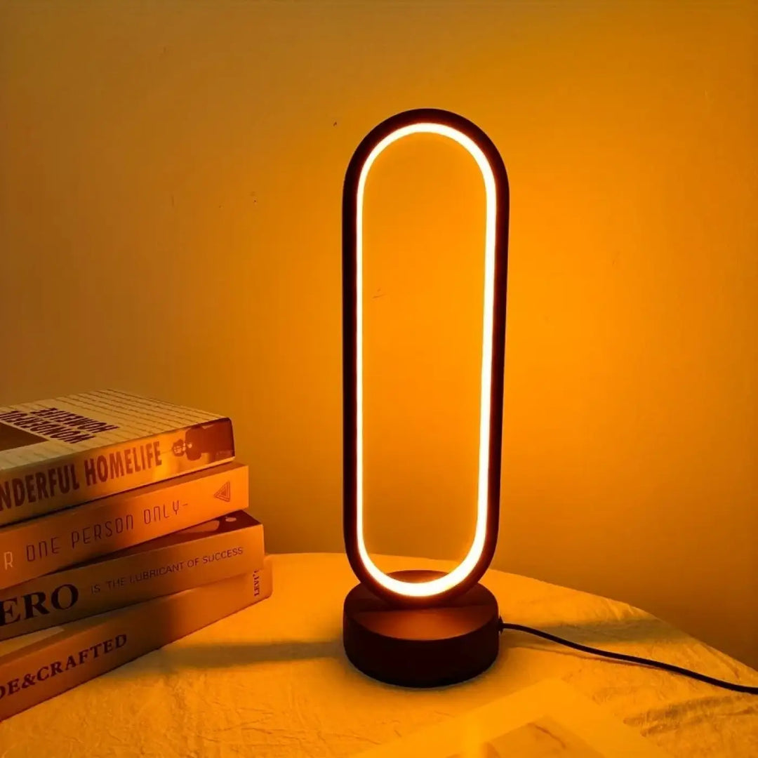 Veilleuse moderne santillana forme ovale avec lumière led chaude et cadre noir élégant en métal