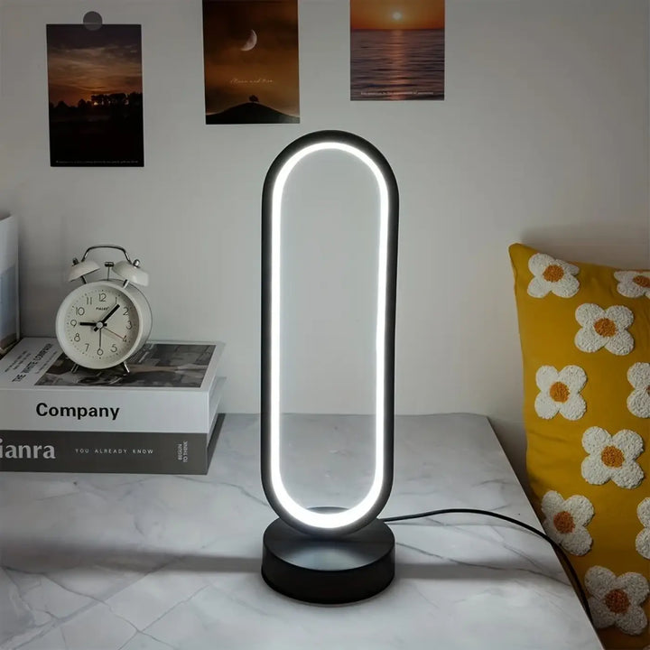 Veilleuse moderne santillana en forme ovale noire avec lumière led blanche en anneau lumineux